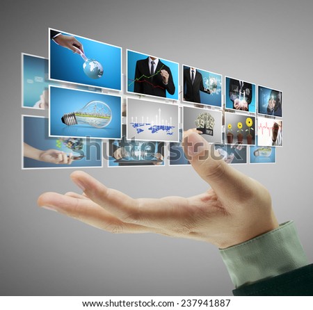 Businessman touch screen to choose digital photos