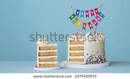 Birthday cake with slice removed and banner reading happy birthday