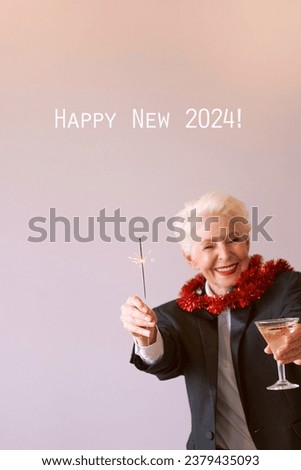 stylish mature senior woman in tuxedo with sparkler and glass of wine celebrating new year. Fun, party, style, celebration concept