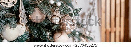 Diy wooden, paper christmas ornaments hanging from Christmas tree.Festive winter holidays background, Christmas card.web banner
