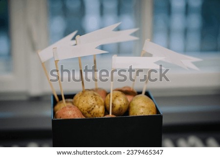 White flags stuck in potatoes