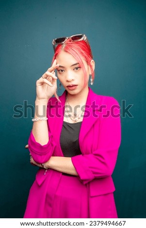 Red hair color of an Asian over blue background. Office attire fashion.
