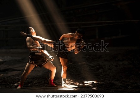 Muay Thai boxers with kick boxing action, thai fighters training boxing in the dark Royalty-Free Stock Photo #2379500093
