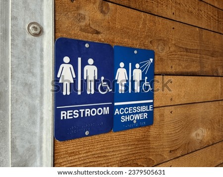 Restroom signs for men, women and handicapped in an outdoor facility