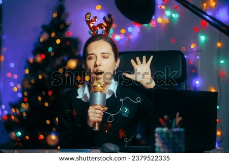
Woman With Karaoke Microphone Singing Christmas Carols at the Office
Party girl having fun at the office Xmas party 
 Royalty-Free Stock Photo #2379522335