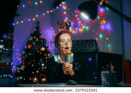 
Woman With Karaoke Microphone Singing Christmas Carols at the Office
Party girl having fun at the office Xmas party 
