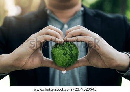 Concept of the Environment World Earth Day. Hands holding green earth, Saving environment, and environmentally sustainable.