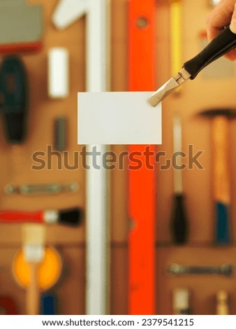 DIY and home improvement banner with work and construction tools on a  workbench top view, blank white business card at centre