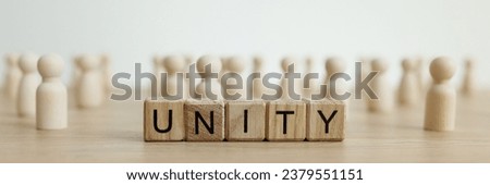 Word Unity made of wooden cubes against white figures symbolizing union for common purpose. Blocks made of wood and group of figurines on table