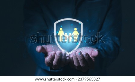 Human hand holding shield to protect family, life, health, insurance, real estate, support, insurance company, hospital, life insurance concept.