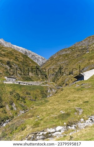 Scenic view of historic mountain pass road named Tremola at Swiss Gotthard Pass in the alps on a sunny late summer morning. Photo taken September 10th, 2023, Gotthard, Switzerland.