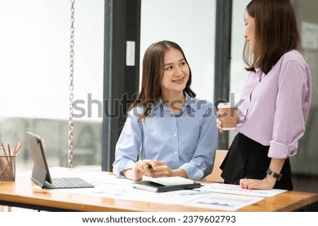 Young Asian business woman working and talking at the office
