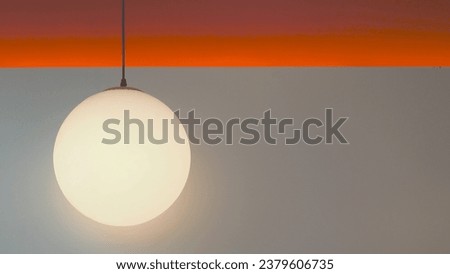 picture of orange round lamp on gray and orange wall texture Background