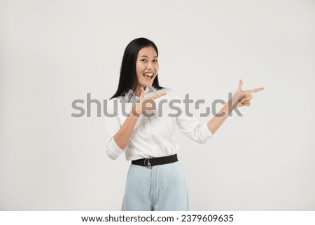 Photo of smiling asian young office woman, asian business entrepreneur pointing fingers left, showing client info, chart of banner aside on copy space, white background.