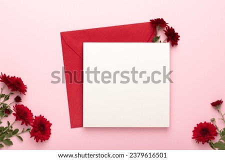 Burgundy chrysanthemums and a red envelope with a blank letterhead on a pink background.
