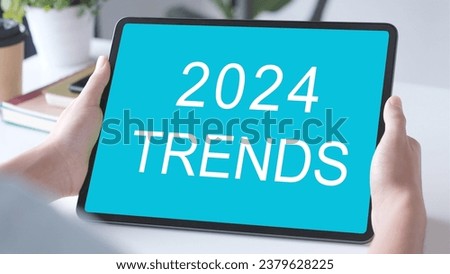 Digital tablet with 2024 trends on screen background, digital marketing, business and technology concept