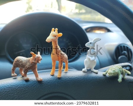 small figurines of animals in the car. toy animals.