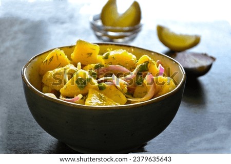 Bowl of potato onion salad, greek food, lemon slices, food picture