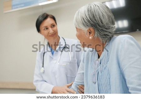 Medicine, healthcare and people concept - female doctor talking to smiling senior woman patient at hospital Royalty-Free Stock Photo #2379636183