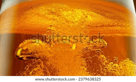 Detail of Pouring Beer Into Glass, Close-up. Abstract Beverages Background. Royalty-Free Stock Photo #2379638325