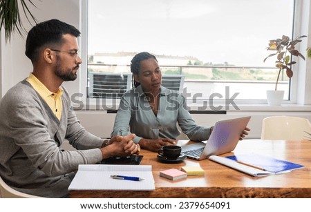 Two young freelance business people, staff meeting, analysing and advisory at modern office. Business partners, small company owners, working on new project. Brainstorming concept Royalty-Free Stock Photo #2379654091