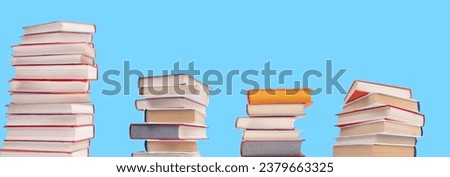Composition with hardback books on wooden deck table and blue background. Books stacking. Back to school. Copy Space. Education background