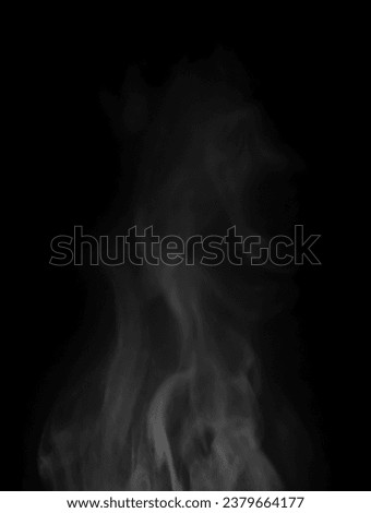 Abstract white puffs of smoke swirl overlay on black background pollution. Royalty high-quality free stock image of abstract smoke overlays on black Vertical backgrounds. White smoke swirls fragments