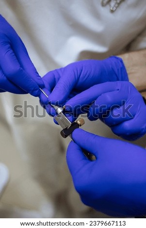 close-up of dentist's hands. Manipulating a dentist's instrument