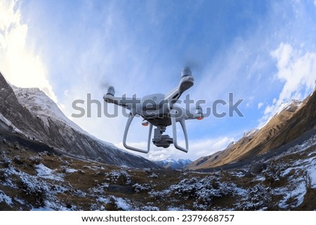 White flying drone taking picture of landscape in Tibet, China