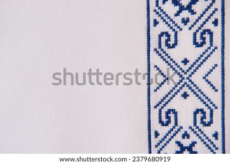 Texture of homespun linen textile with embroidery. Design of ethnic pattern. Craft embroidery.