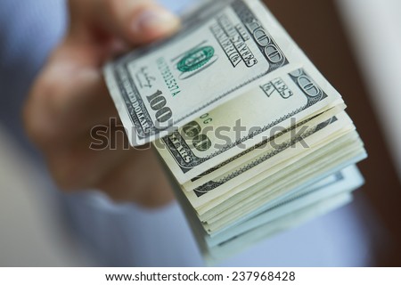  money in hand  Royalty-Free Stock Photo #237968428