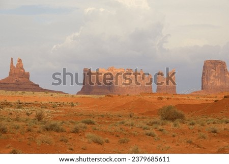 Monument valley, red rock, cloudy sky, rock mountains, scenic view, sunset background, Arizona landscape, Usa.