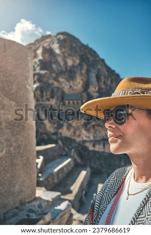 Traveler hipster girl in hat with backpack exploring ruins of Ollantaytambo Ruins in Sacred Valley of Peru Royalty-Free Stock Photo #2379686619