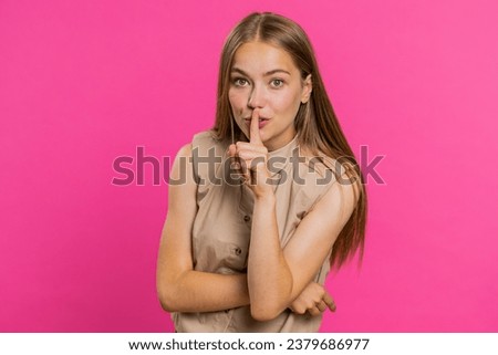 Shh be quiet please. Young woman presses index finger to lips makes silence gesture sign do not tells secret, stop gossip. Pretty attractive blonde girl isolated alone on pink studio background
