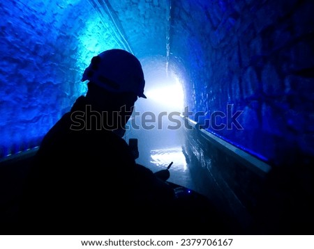 Silhouette of a miner in an underground mine on a boat.