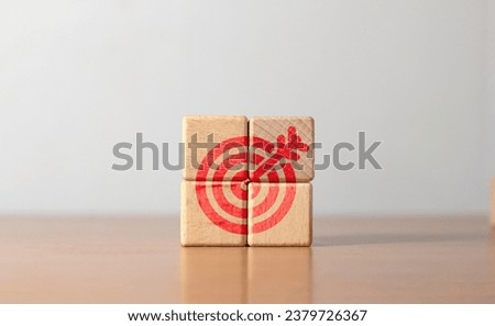 Four wooden blocks with red dart symbols. The idea of ​​setting goals and moving towards them. Setting goals for work Royalty-Free Stock Photo #2379726367