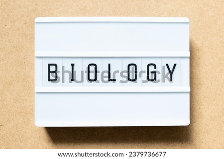 Lightbox with word biology on wood background