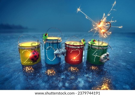 homemade new years lantern with 2024 and burning candles in the night Royalty-Free Stock Photo #2379744191