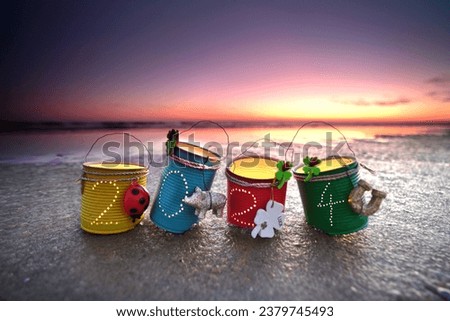 new year lanterns from homemade cans with 2024 and candles                                Royalty-Free Stock Photo #2379745493