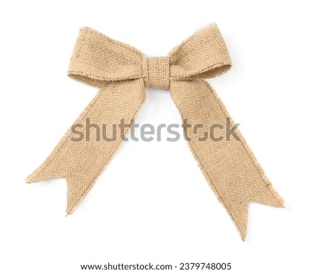 Bow made of burlap fabric isolated on white, top view Royalty-Free Stock Photo #2379748005