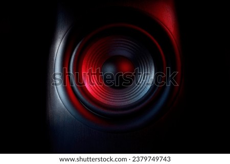 One sound speaker in neon light on black background, closeup Royalty-Free Stock Photo #2379749743