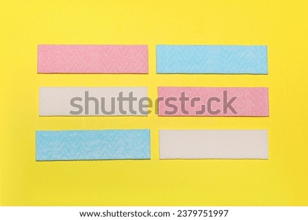 Sticks of tasty chewing gum on yellow background, flat lay