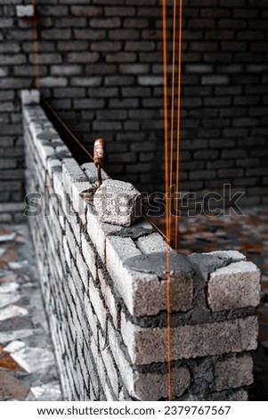Laying bricks. Construction of a new house. Construction of a brick house.