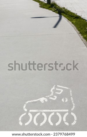 Sign of rolls on asphalt street or sidewalk. Safety during active resting. Marking for skaters