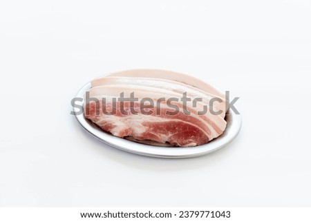 Sliced ​​pork belly placed on a plate for a shabu grill menu. on a white background Sliced ​​pork neck, food picture for making a menu