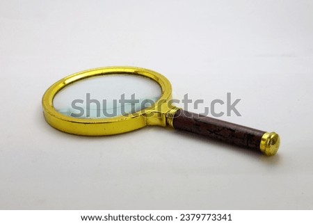 Gold color magnifying glass with isolated white