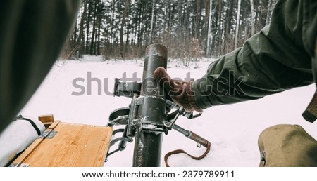 Close-up View On Re-enactors Dressed As American Infantry Soldiers Prepare Fire From Mortar. Usa Army Soldiers Of World War Ii. Mortar Shooting Forest. Reconstruction Defense Battles. Heroes Of War. Royalty-Free Stock Photo #2379789911