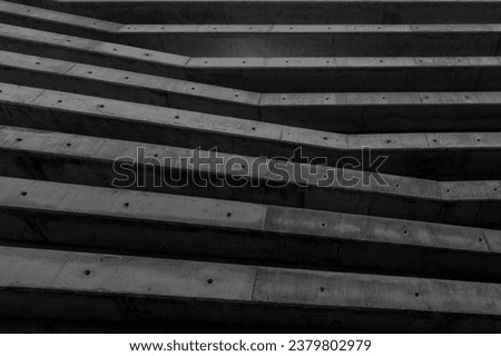 abstract architeture background made of geometric shape wall pattern. exterior detail. contemporay construction with large cement columns or beams grid. brutalist structure buildind. Black and white Royalty-Free Stock Photo #2379802979
