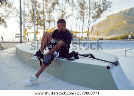 Latin American man with leg disability prepares to skateboard	