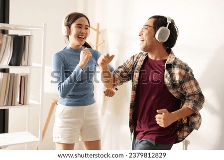 Happy Couple at Home, dancing to the Rhythm of Good Vibes with Happiness. Royalty-Free Stock Photo #2379812829
